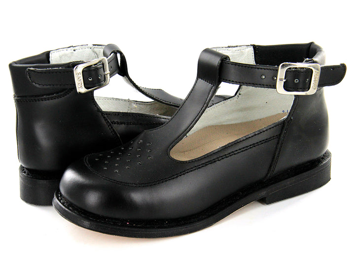 Par de zapatos escolares negros para niña con correa y hebilla plateada sobre fondo blanco.