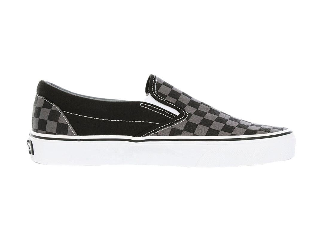 Tenis Vans Classic Slip-On con estampado de cuadros en color negro y gris con suela blanca.