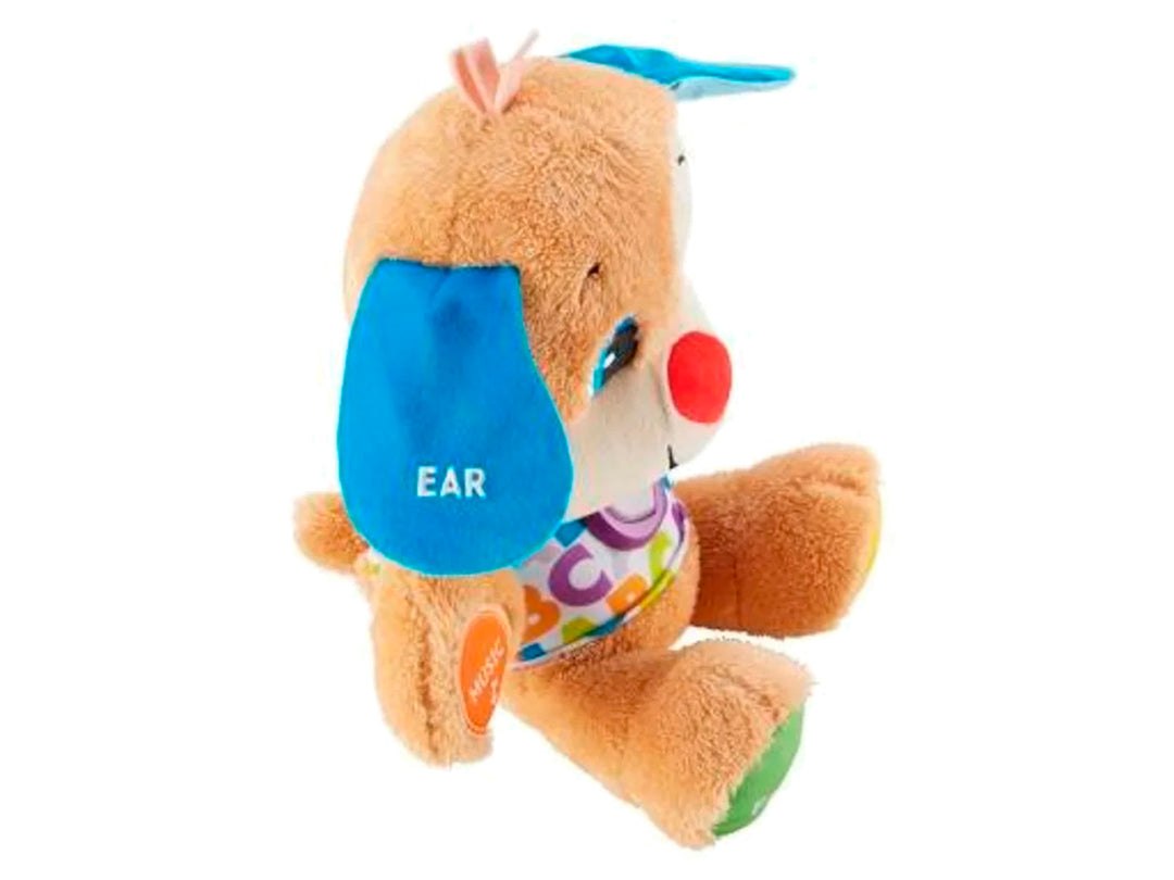 Perro de peluche educativo Fisher-Price en su empaque, con colores brillantes y botones interactivos.