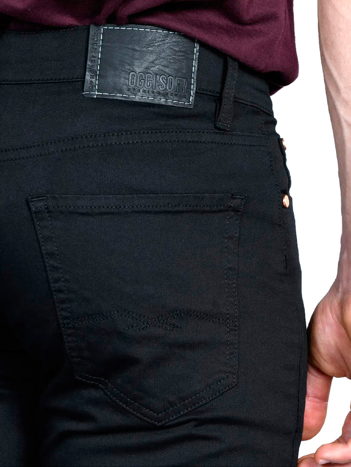 Hombre vistiendo pantalones jeans color negro de corte ajustado.