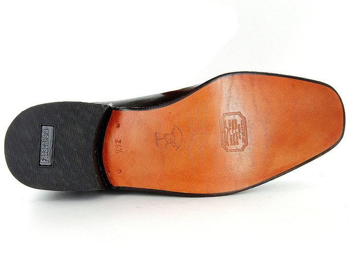 Zapatos mocasines negros de cuero con detalle de textura tipo cocodrilo en la parte superior.