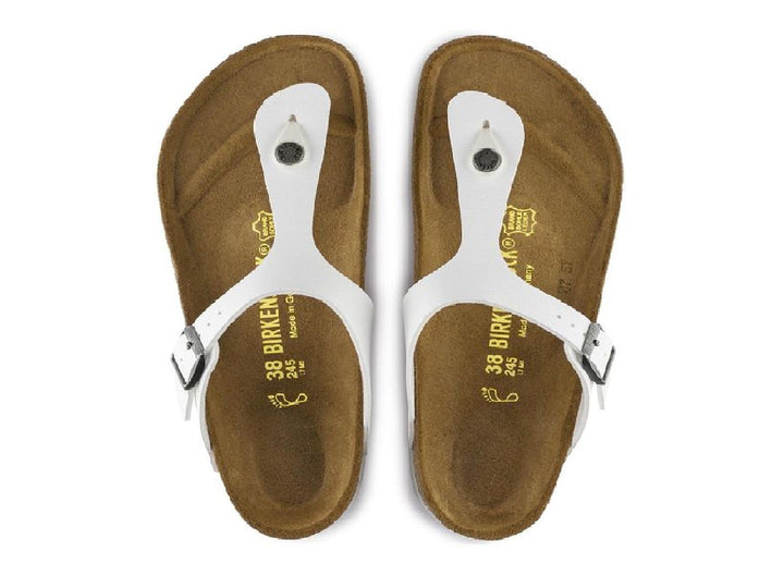Sandalia blanca Birkenstock para mujer con plantilla de corcho y hebilla metálica.