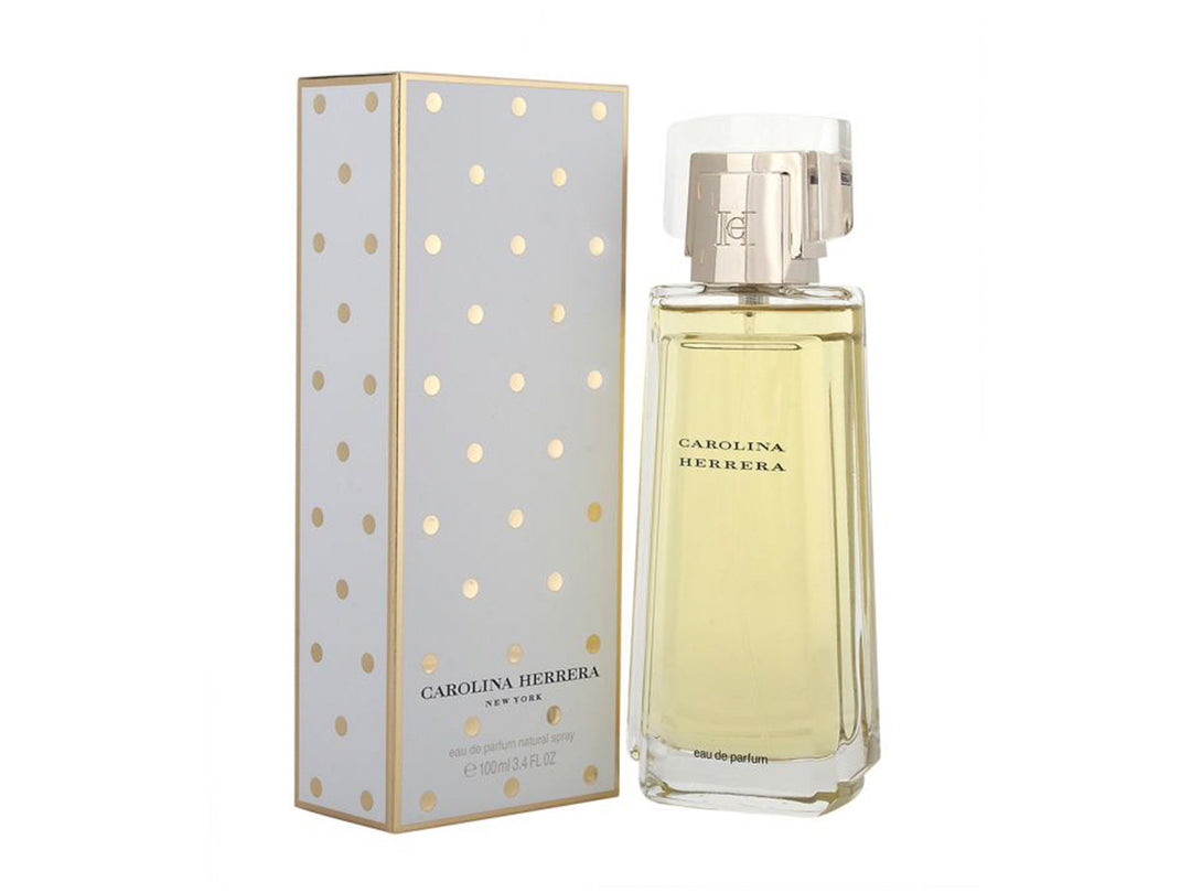 Perfume Carolina Herrera New York con botella de vidrio y caja blanca con puntos dorados.