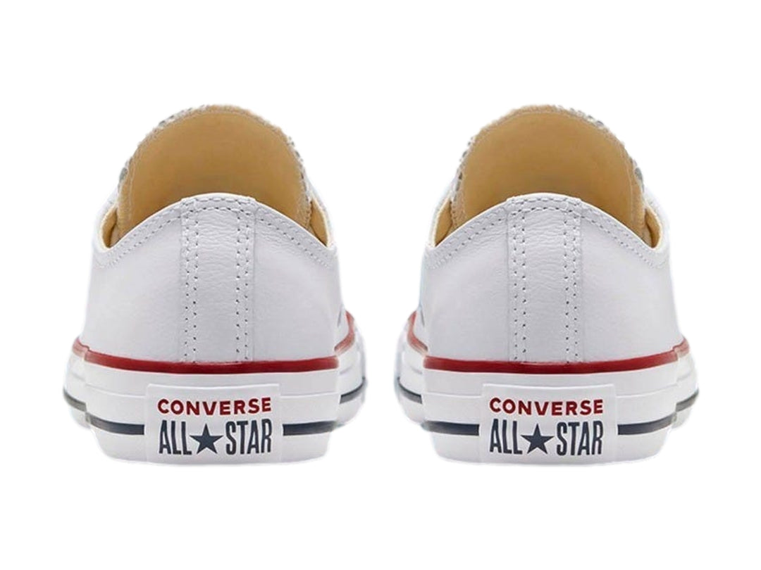 Tenis Converse Chuck Taylor All Star Ox en color blanco con detalles rojos y azules en la suela.
