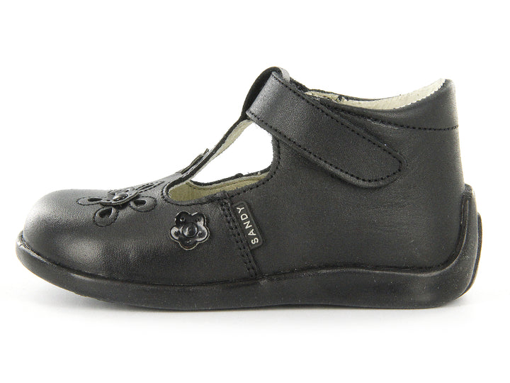 Par de zapatos negros para niña con correa de velcro y detalles de flores en relieve sobre el empeine.