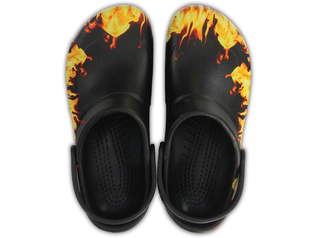 Zuecos Crocs Bistro negros con diseño de llamas en colores amarillo y naranja.