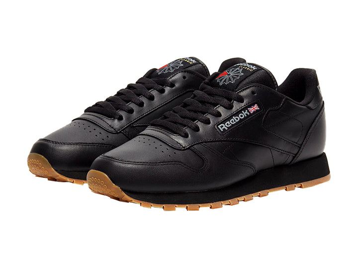 Tenis Reebok color negro con suela de goma color miel para hombre.