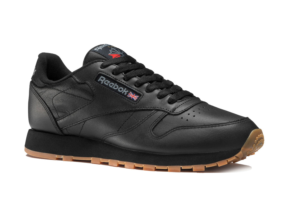 Tenis Reebok color negro con suela de goma color miel para hombre.