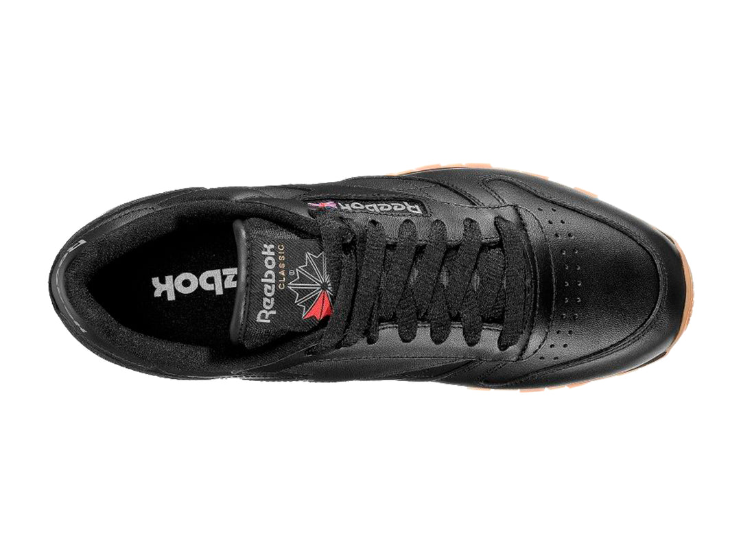 Tenis Reebok color negro con suela de goma color miel para hombre.