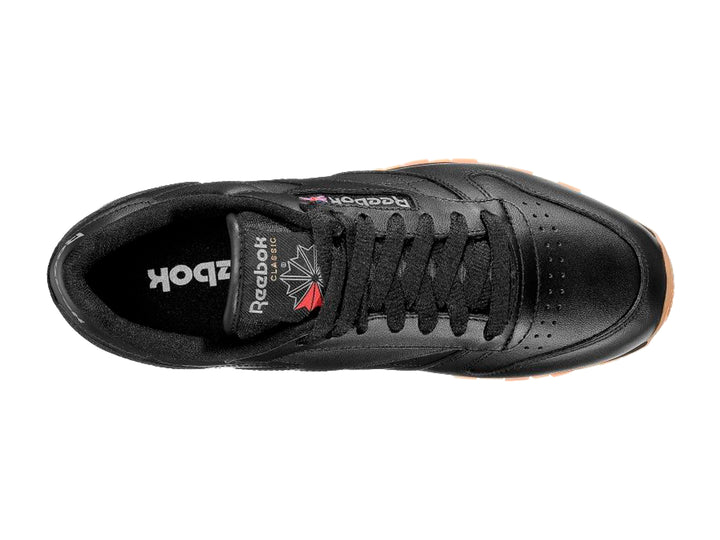 Tenis Reebok color negro con suela de goma color miel para hombre.
