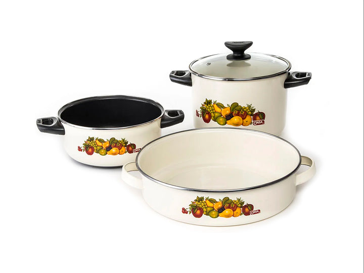 Batería de cocina blanca de 7 piezas con detalles de vegetales y mangos negros.