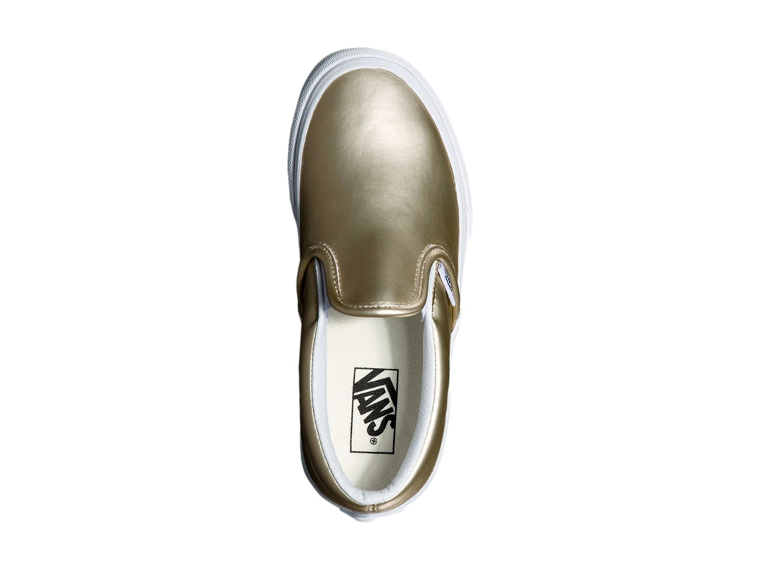 Zapato Vans slip-on para niño en color dorado metálico con suela blanca clásica.