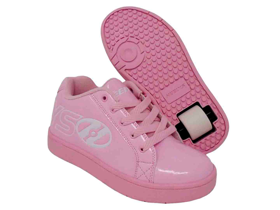 Tenis patín Heelys para niña en color rosa brillante con rueda blanca en el talón.