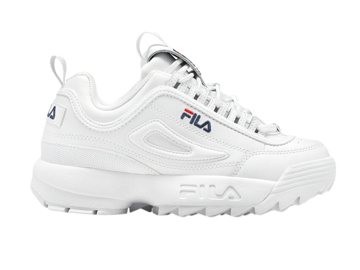 Tenis FILA Disruptor Premium en color blanco con detalles mínimos en azul y rojo, suela gruesa y dentada.
