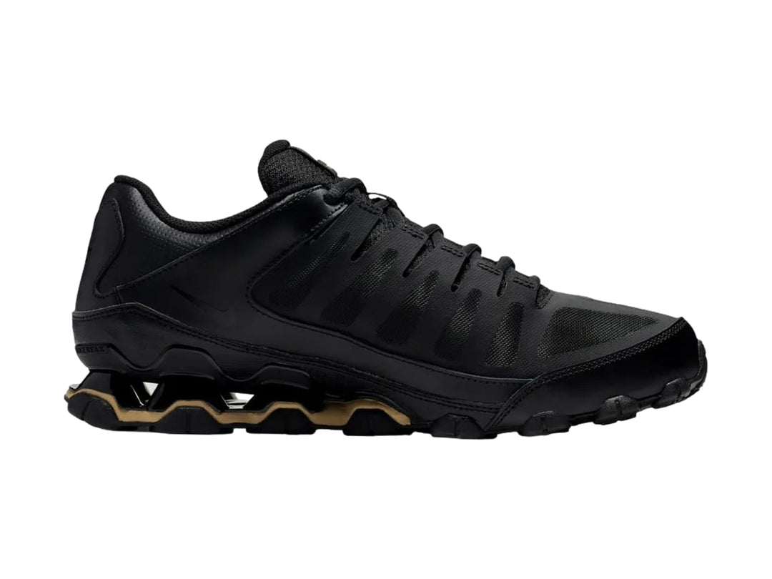 Tenis Nike Reax 8 TR Mesh en color negro con detalles dorados en la suela, diseño deportivo y malla transpirable.