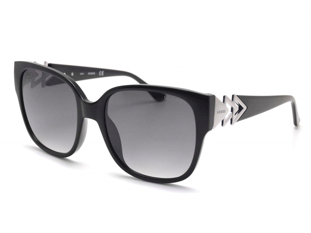 Lentes de sol Guess negros con micas degradadas y detalle metálico plateado en las varillas.