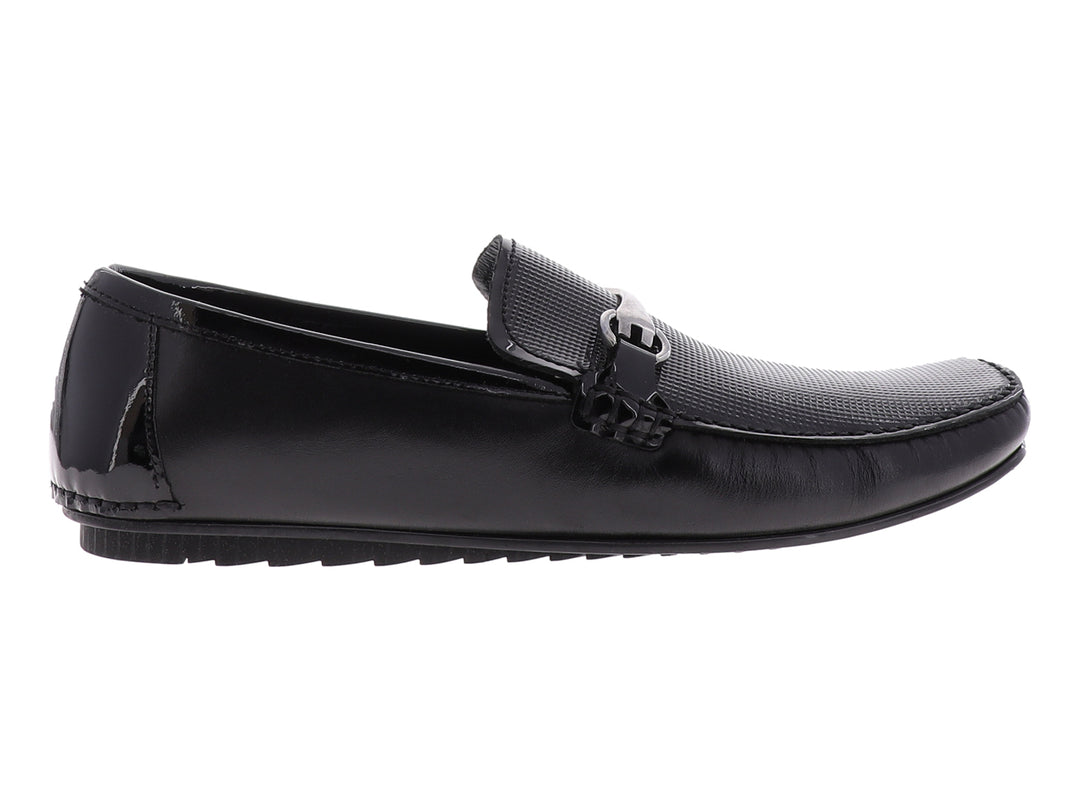 Zapato tipo mocasín Gino Cherruti en color negro con acabado de charol y detalle metálico superior.