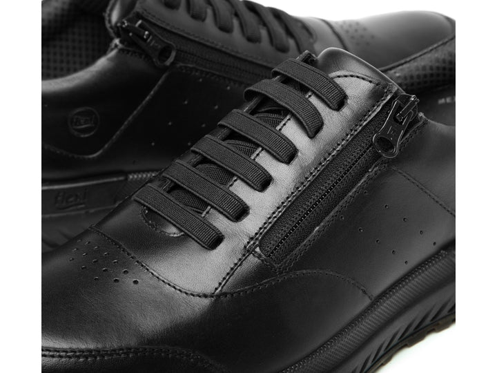 Tenis Flexi Ocon para hombre en color negro con cierre lateral y suela color café.