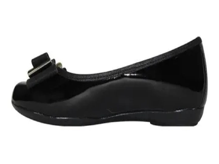 Zapato plano negro brillante para niña con detalle de moño en la parte frontal.