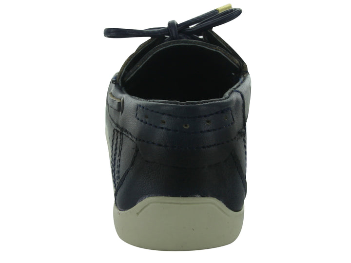 Zapatos casuales tipo náutico para niño en color azul marino con suela blanca y cordones.