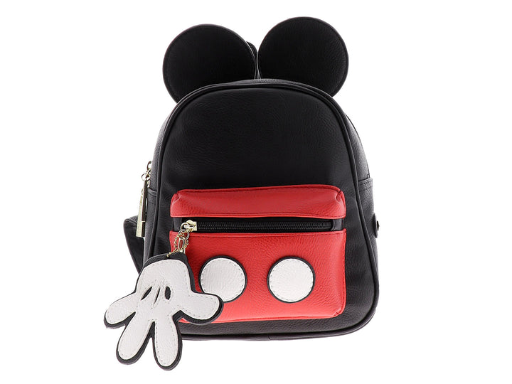 Mochila pequeña negra y roja con orejas decorativas y un colgante blanco en forma de mano.