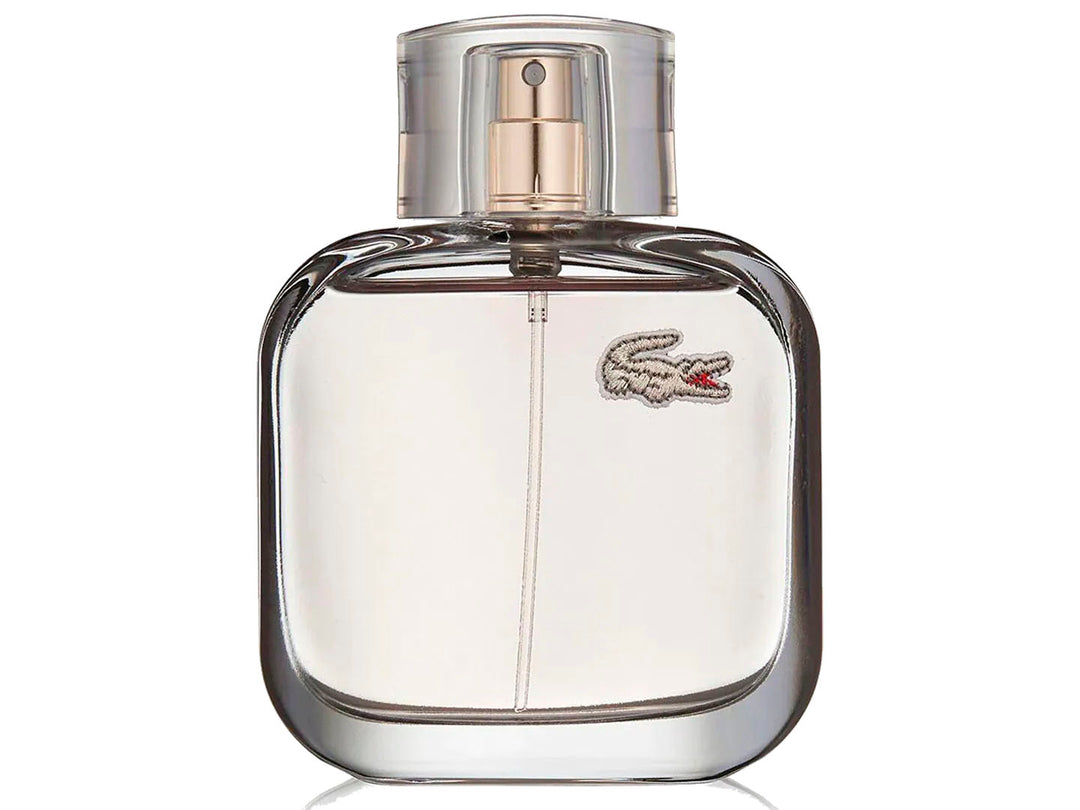 Botella de perfume Lacoste L.12.12 Pour Elle Elegant transparente junto a su caja blanca.