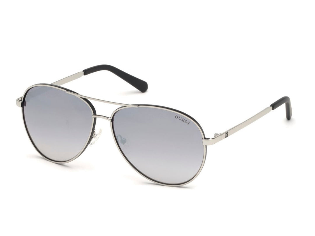 Lentes de sol Guess estilo aviador con montura plateada y cristales en tono gris degradado para hombre.