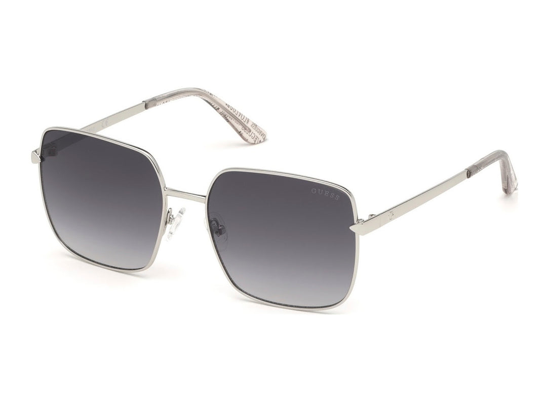 Lentes de sol Guess para mujer con montura metálica plateada y cristales en color gris degradado.