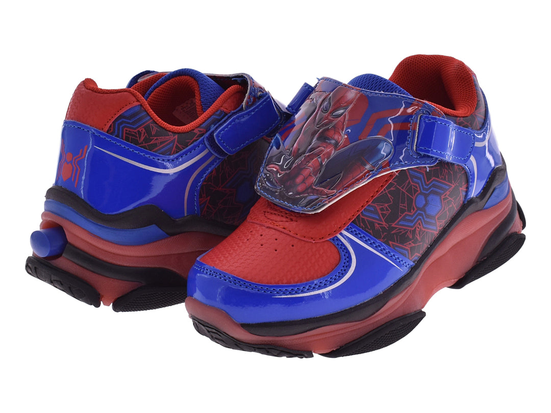 Tenis deportivos para niños en colores rojo y azul con diseño temático y cierre de velcro.