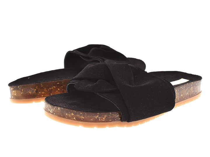 Sandalias negras con correa anudada y suela translúcida color ámbar.