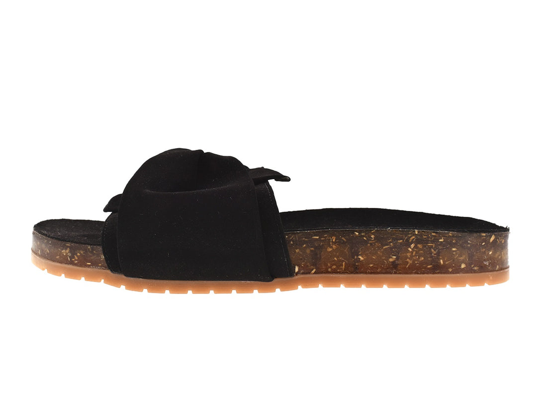 Sandalias negras con correa anudada y suela translúcida color ámbar.