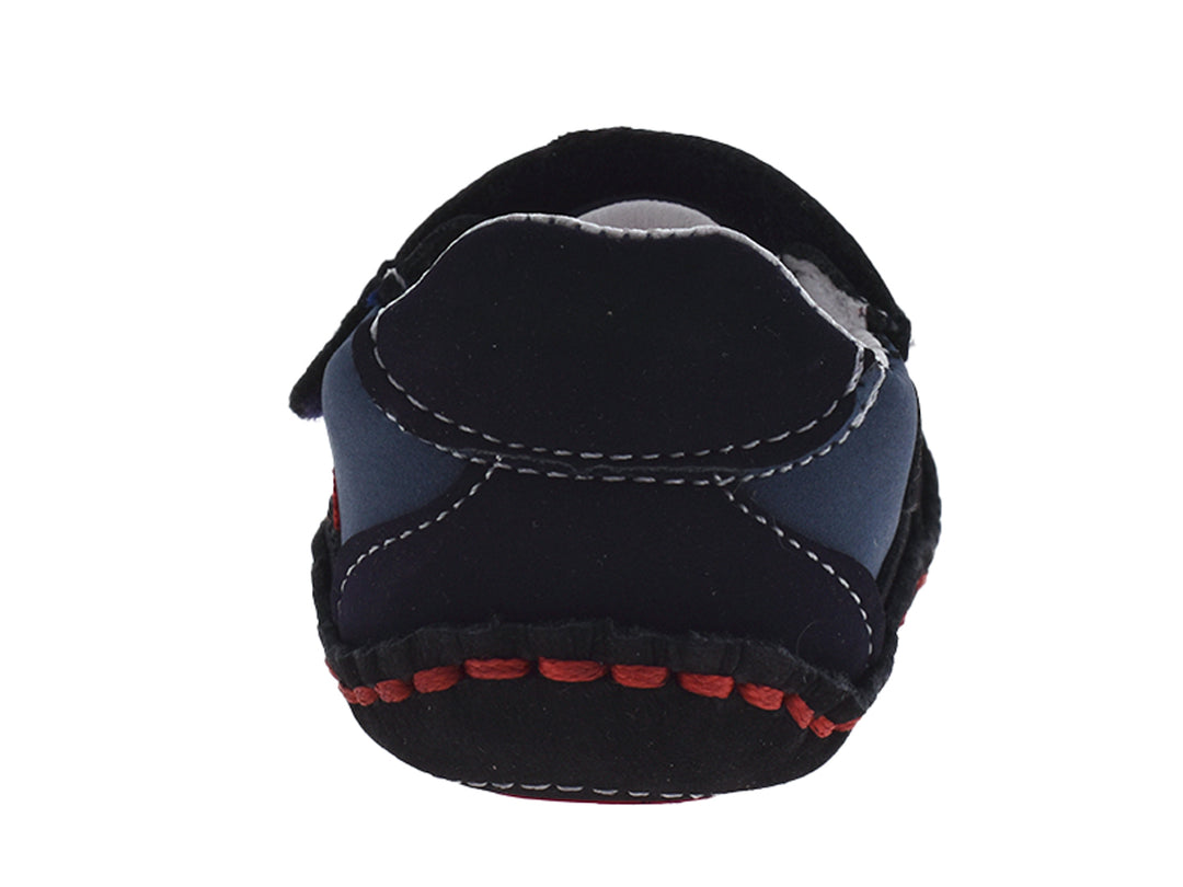 Zapatos para bebé color azul índigo con detalles en rojo y cierre de velcro.