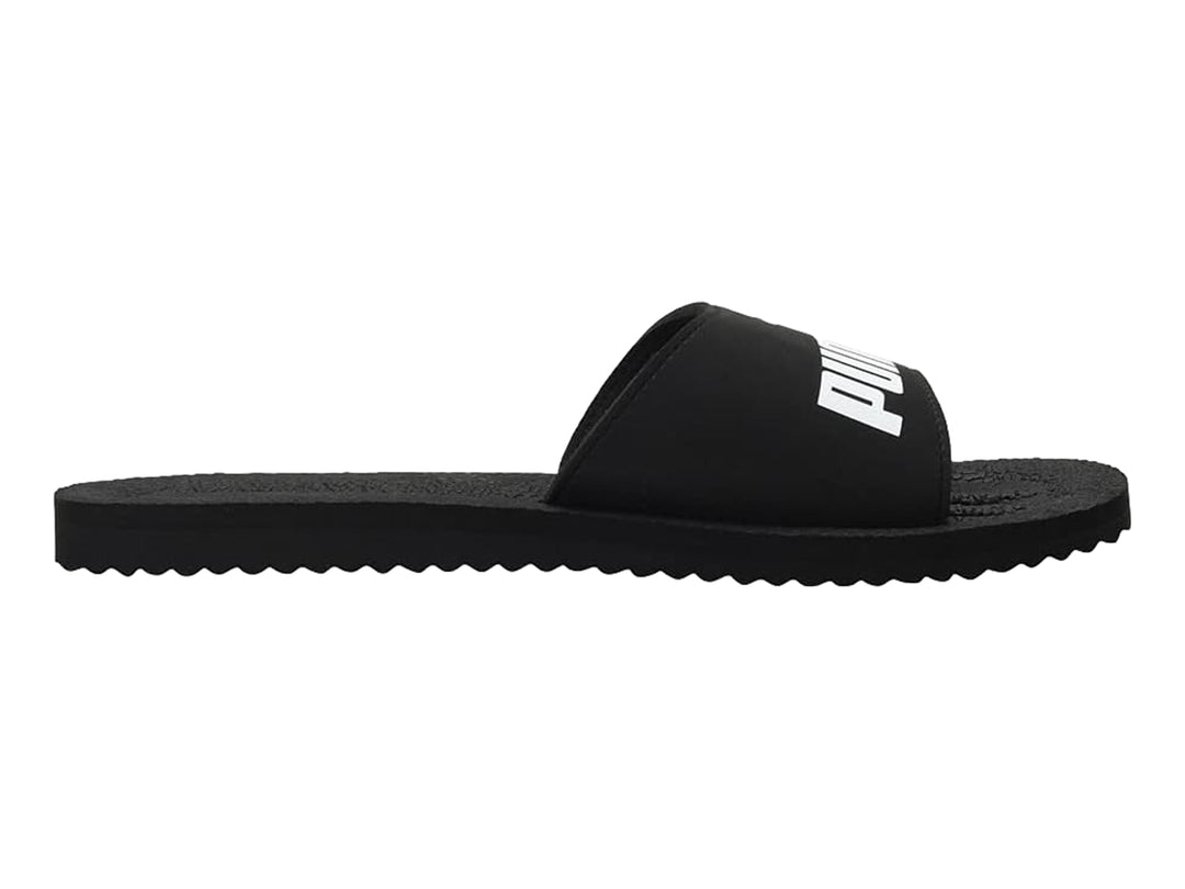 Sandalias PUMA PureCat en color negro con logotipo blanco en la banda superior.
