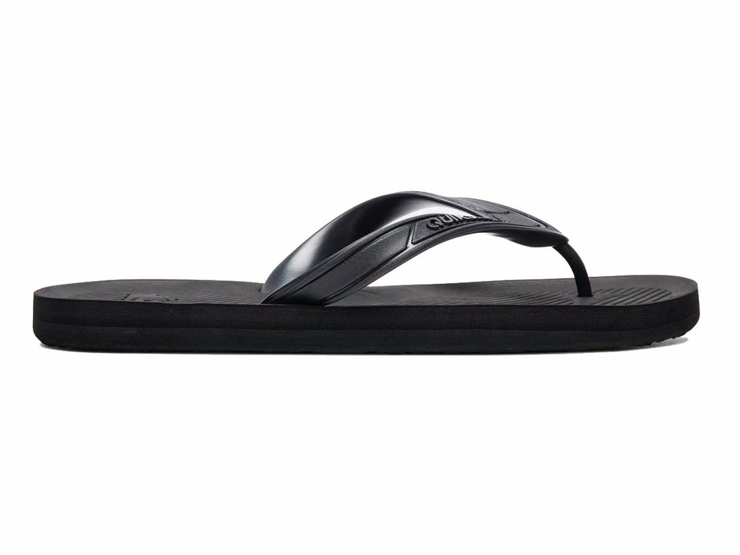 Sandalias Quiksilver color negro sólido con correa en Y y suela plana.