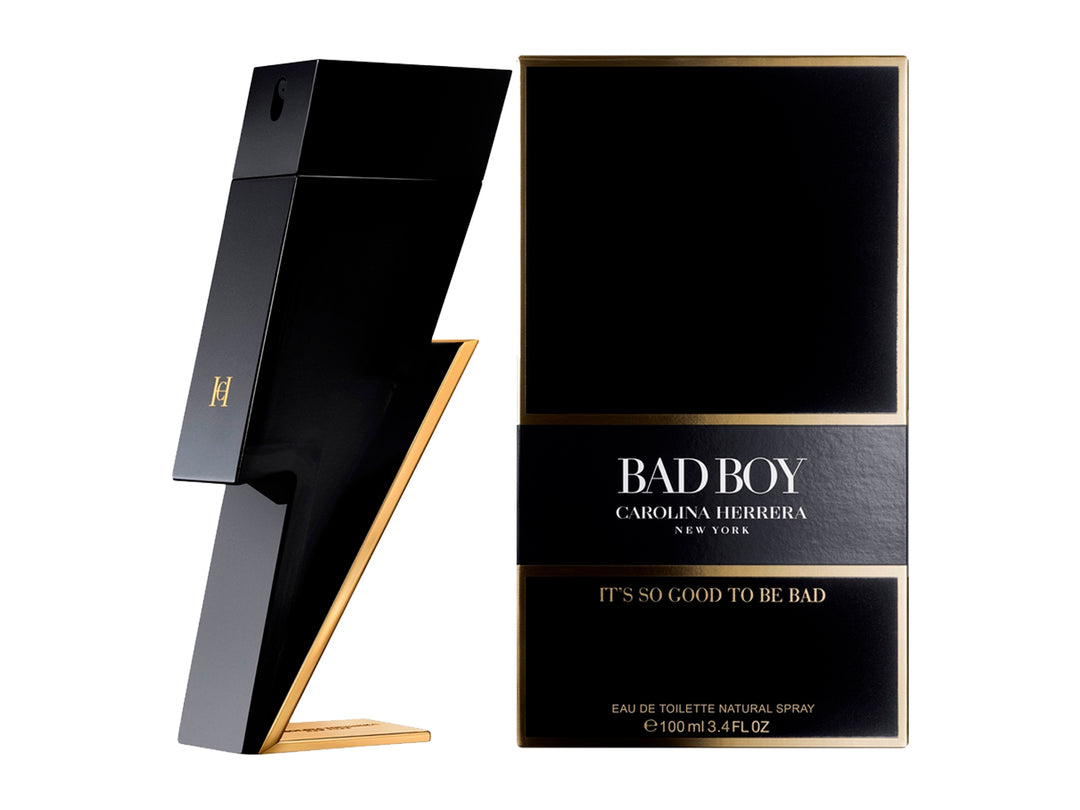 Perfume Carolina Herrera Bad Boy en botella negra con forma de rayo y detalles dorados junto a su caja.