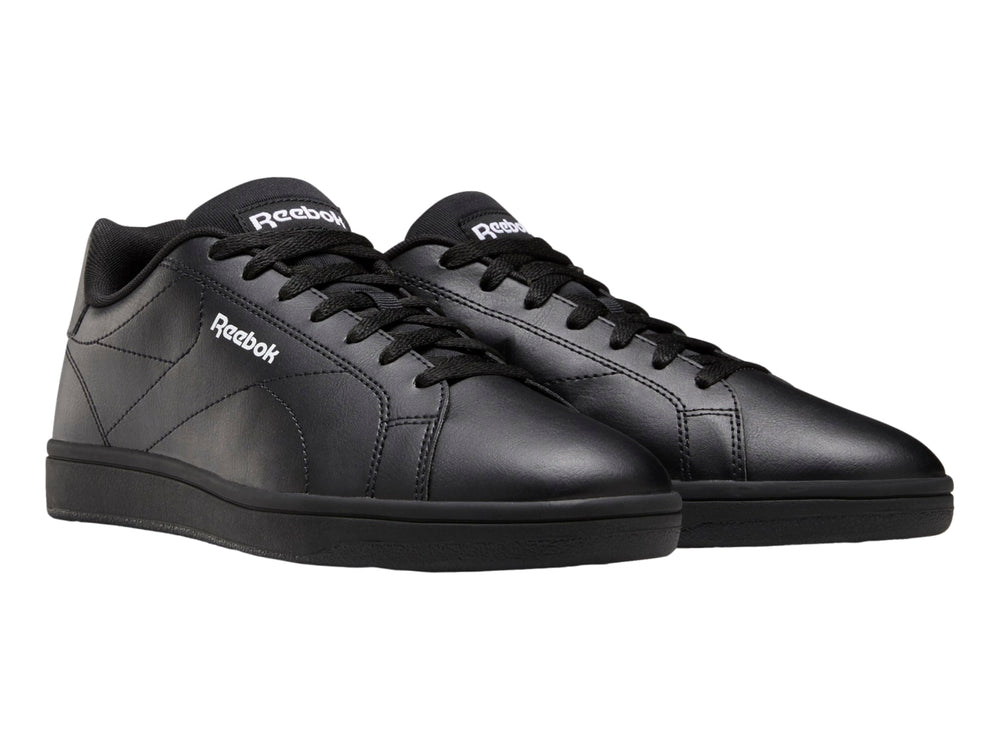 Tenis Reebok color negro con suela plana y diseño deportivo de corte bajo.
