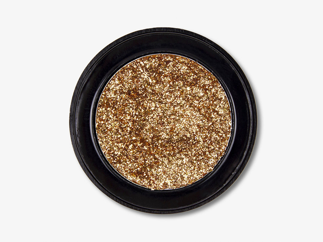 Sombra de ojos glitter color bronce en envase circular negro.