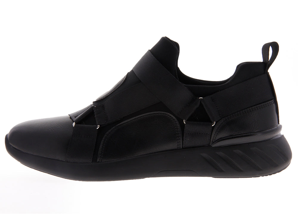 Par de tenis negros estilo slip-on con correas elásticas sobre fondo blanco.