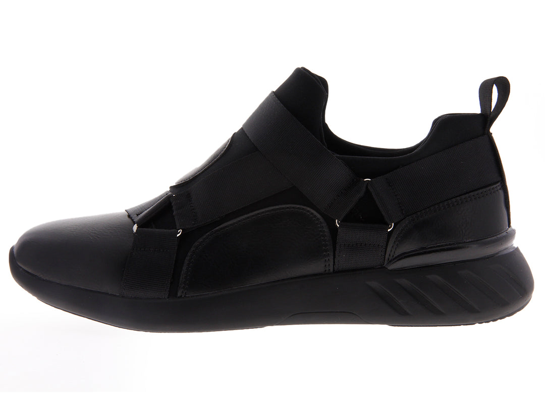 Par de tenis negros estilo slip-on con correas elásticas sobre fondo blanco.