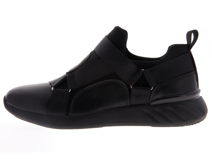 Par de tenis negros estilo slip-on con correas elásticas sobre fondo blanco.