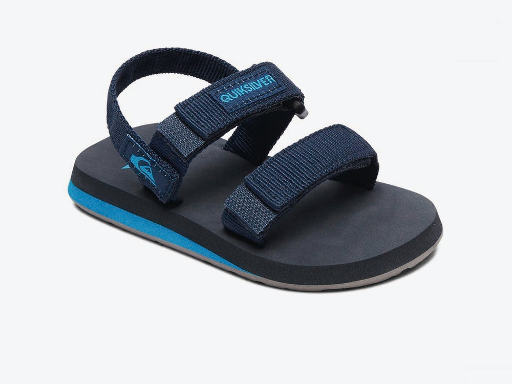 Sandalia infantil Quiksilver color azul marino con suela celeste y correas de velcro.