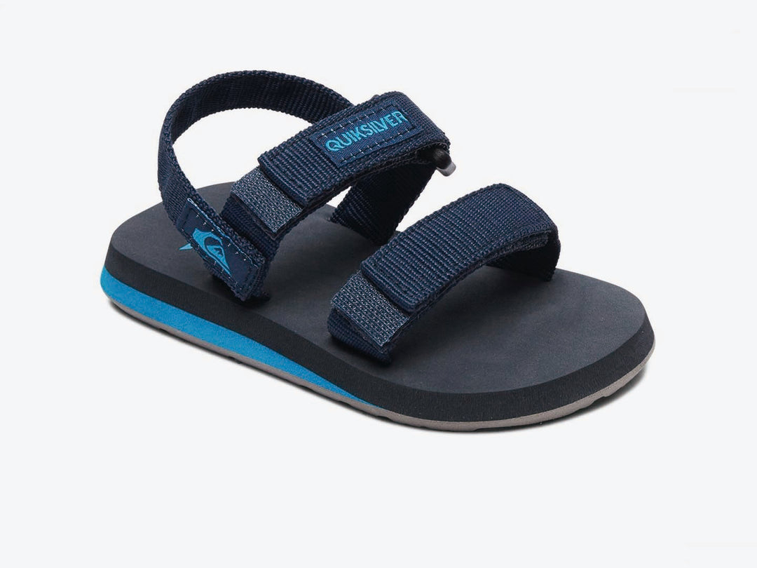 Sandalia infantil Quiksilver color azul marino con suela celeste y correas de velcro.