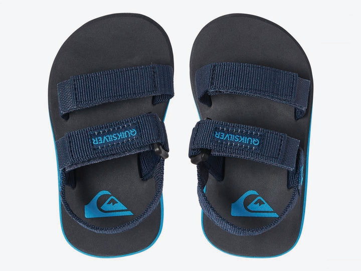 Sandalia infantil Quiksilver color azul marino con suela celeste y correas de velcro.