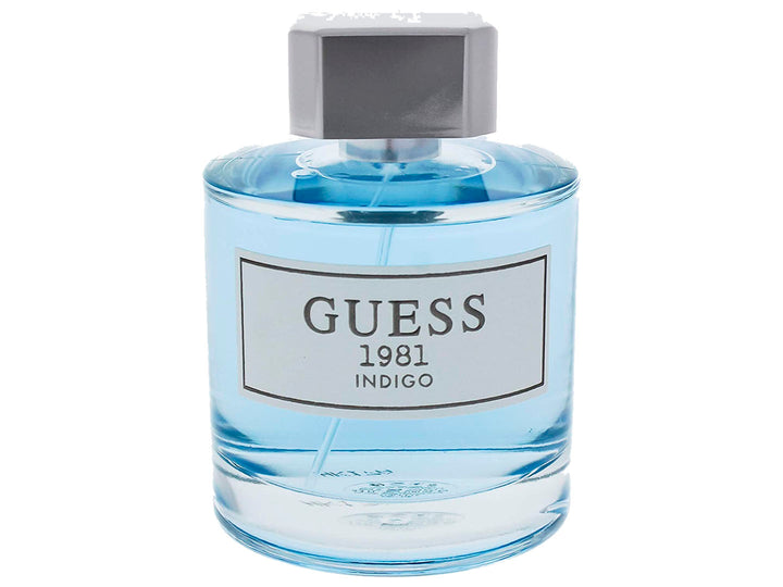 Perfume Guess 1981 Indigo para Mujer, botella de vidrio con líquido azul y su caja coordinada.