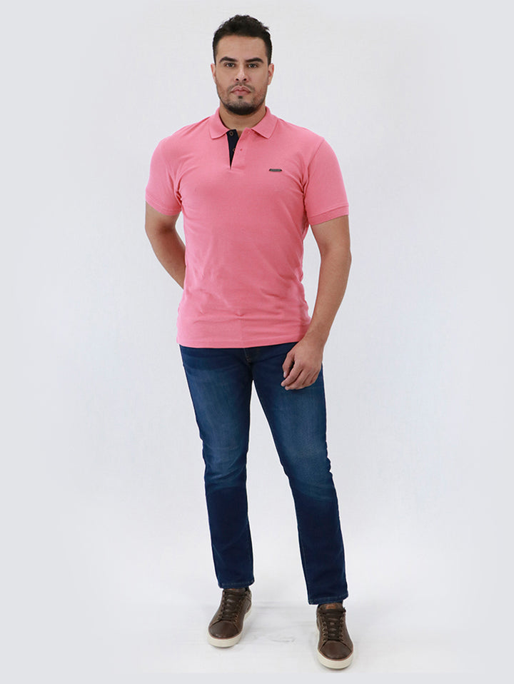 Primer plano de un pantalón de mezclilla azul oscuro para hombre con costuras doradas.