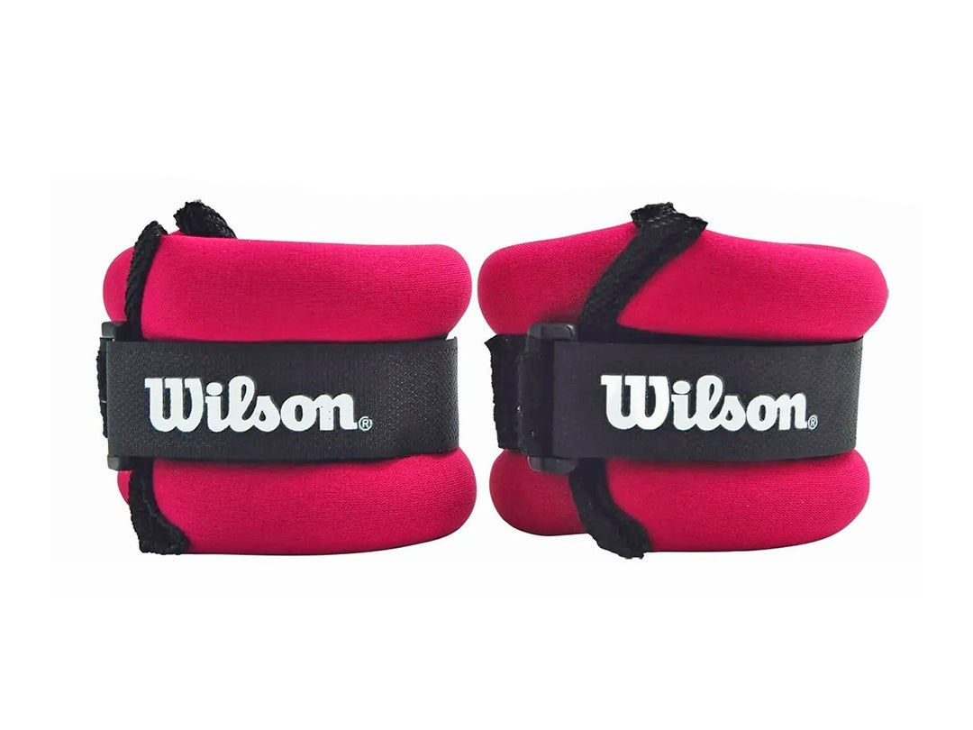 Par de pesas de muñeca Wilson color lila con correas negras ajustables.