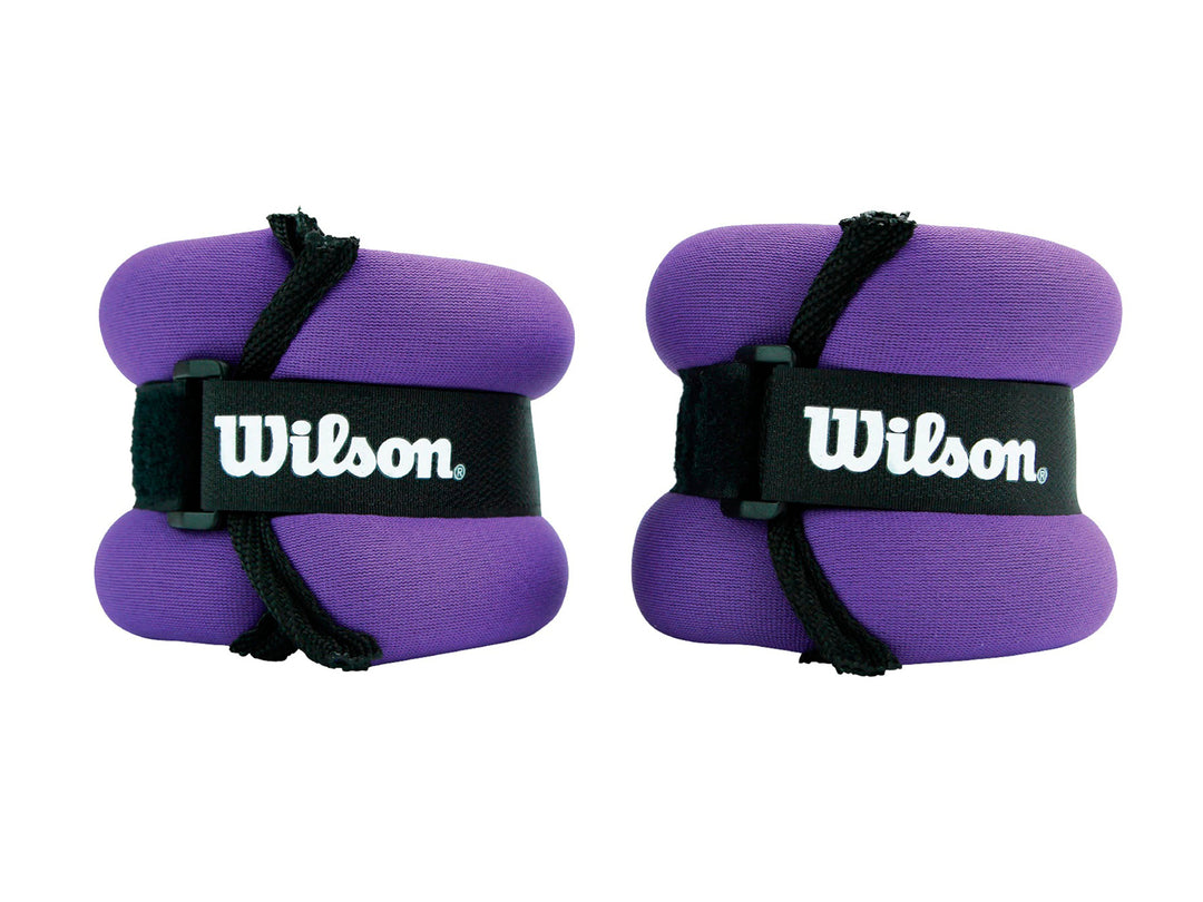Par de pesas para muñecas y tobillos de color morado con correas negras y logotipo de Wilson.
