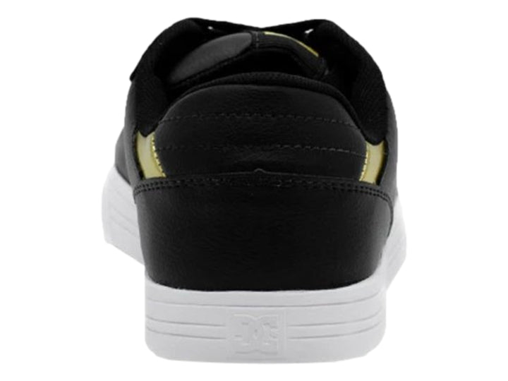 Tenis DC Shoes color negro con suela blanca y detalle dorado en el talón.