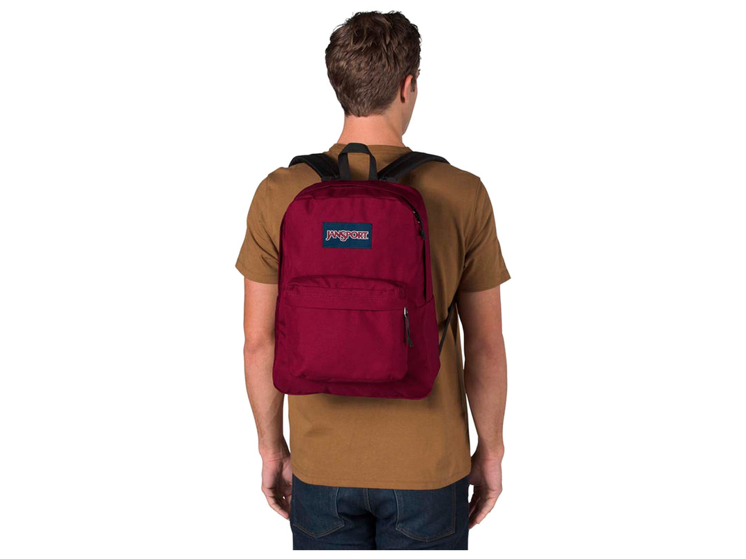Mochila escolar JanSport color rojo russet con bolsillo frontal y asa superior.