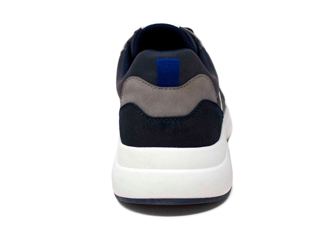 Tenis deportivos Penguin color azul marino con suela blanca y detalles en gris.